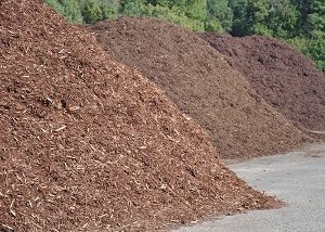 Stockpiles of various kinds of mulch.